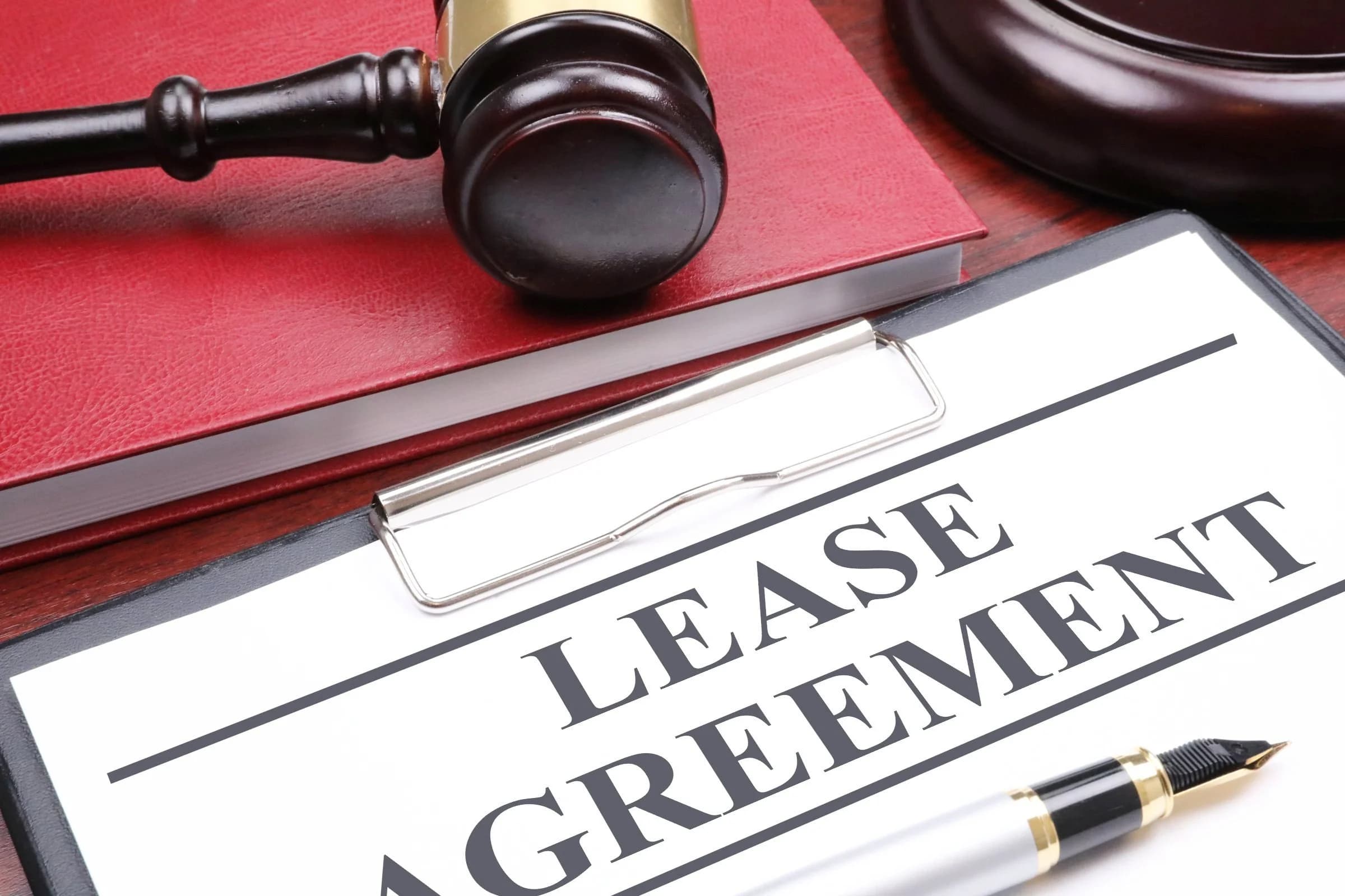 Lease agreement with pen — seven essential features of a compliant WV lease.