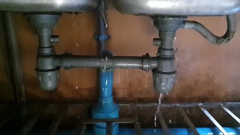 Plumber repairing a sink — what landlords must fix under West Virginia law.